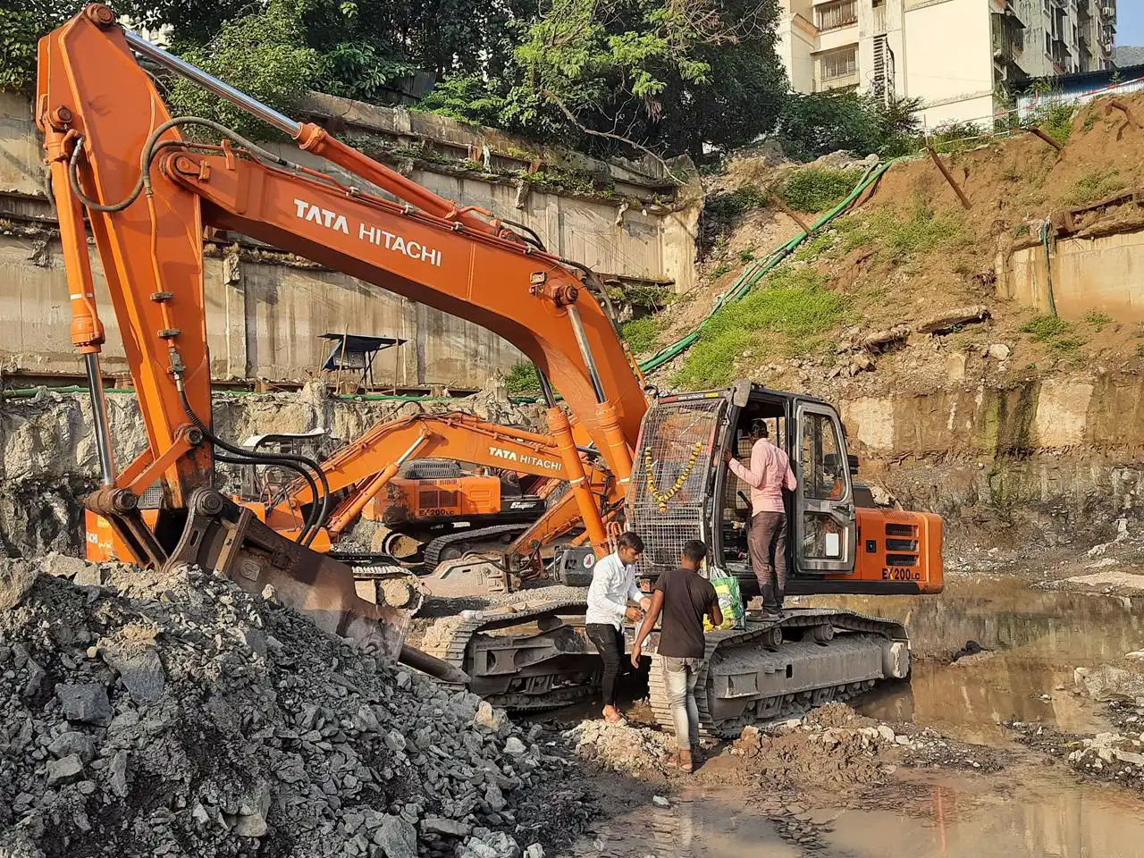 Poclain excavator digging rocky soil at construction site in Ghatkopar Mumbai